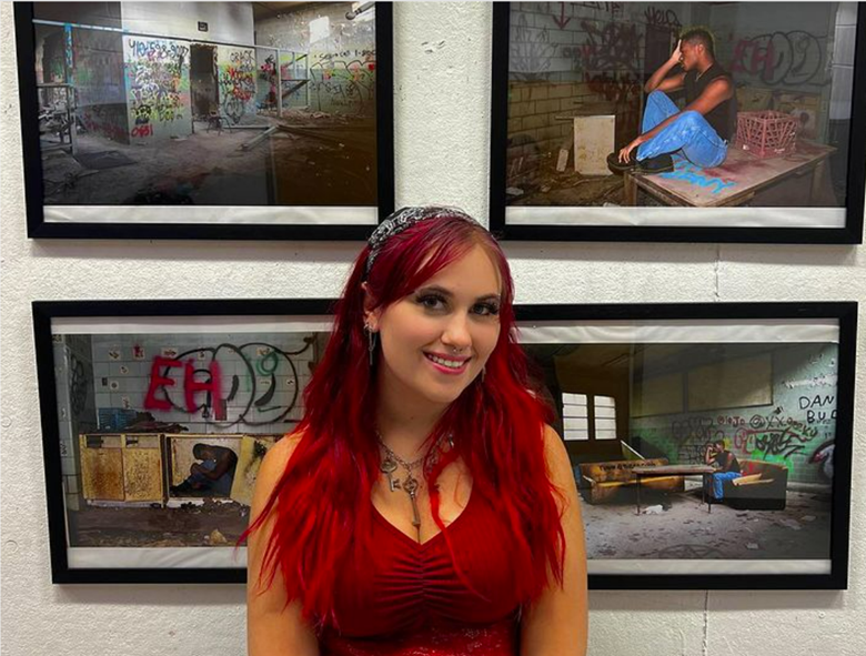 Ryder stands in front of her art show, If Walls could Talk.