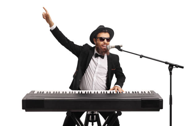 Male artist playing a keyboard and pointing with hand isolated on white background